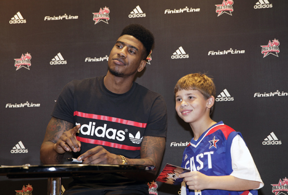 Iman Shumpert of the New York Knicks poses for a photo with a fan at Finish Line at Galleria Mall in Houston during NBA All-Star weekend.