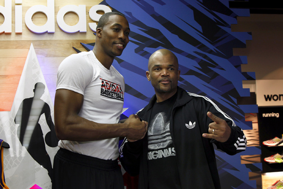 NBA All-Star Dwight Howard of the Los Angeles Lakers and hip-hop legend D.M.C. pose during a fan event at the adidas Store at Galleria Mall during NBA All-Star in Houston.