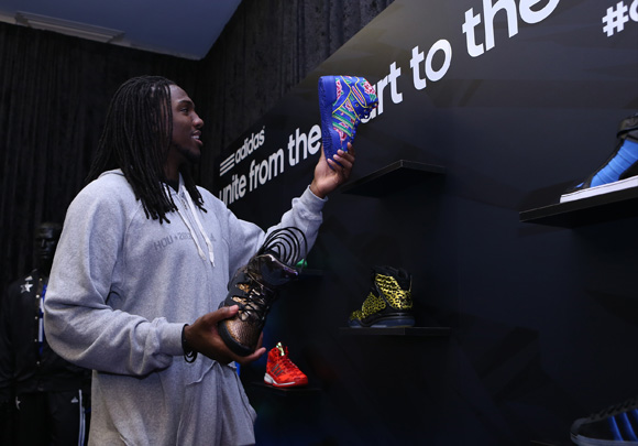 Kenneth Faried of the Denver Nuggets checks out the JS Wings Chinese New Year edition at the adidas VIP suite during NBA All-Star in Houston.