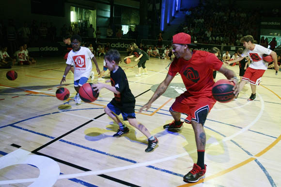 Derrick Rose of the Chicago Bulls participates in a dribbling contest with fans at a basketball event at Canal de Isabel II Sports Centre in Madrid during the adidas D Rose Tour.