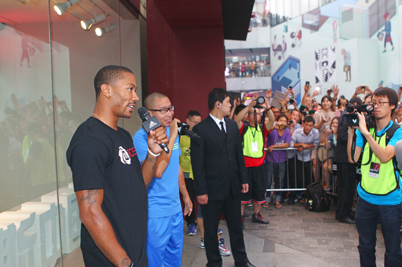 Derrick Rose of the Chicago Bulls is greeted by hundreds of fans outside the Beijing adidas Store.