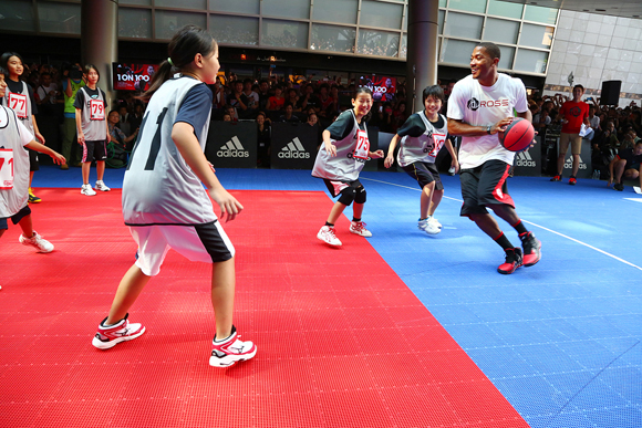 Derrick Rose of the Chicago Bulls plays against a group of Japanese fans at the 1 on 100 event.