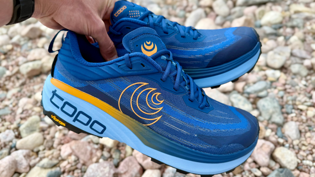 Topo Vista in hand over rock