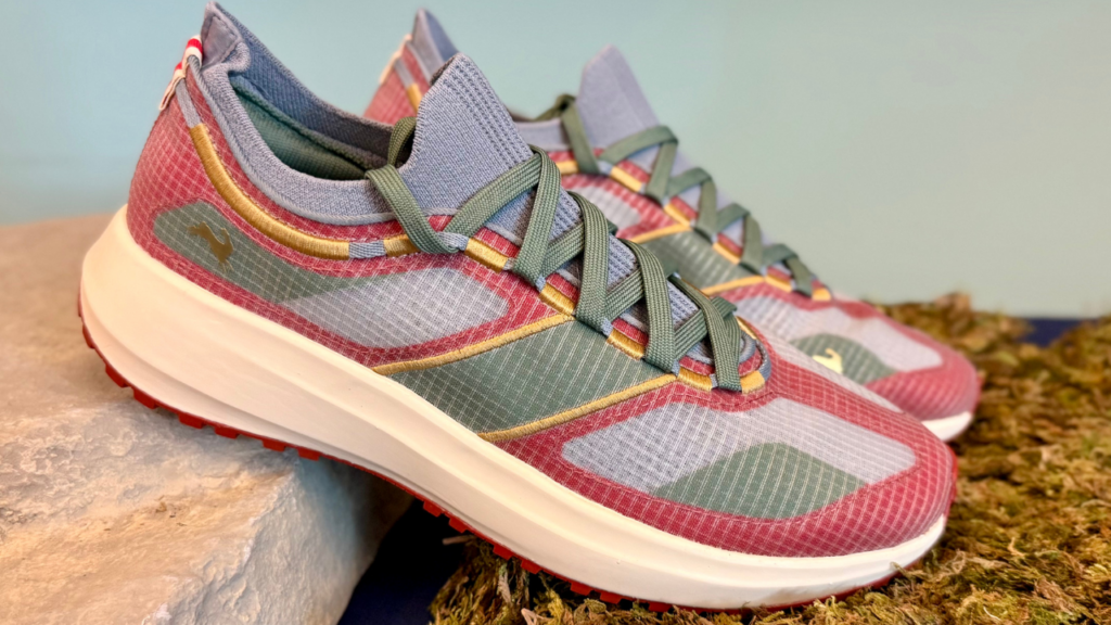 Tracksmith Eliot Range leaning on rock