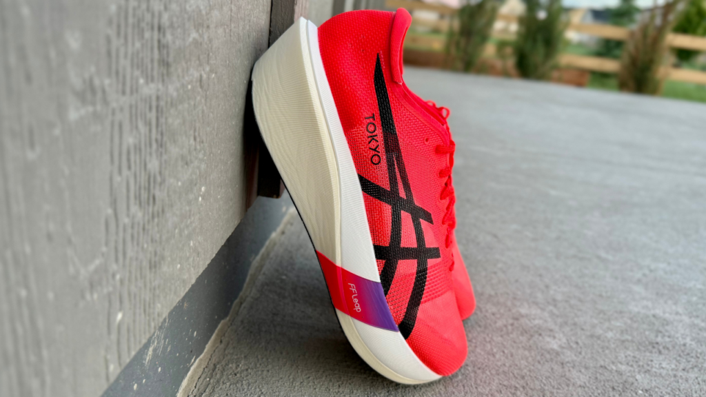 Asics Metaspeed Edge Tokyo leaning on wall
