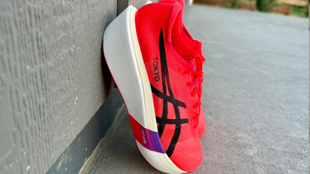 Asics Metaspeed Sky Tokyo leaning on wall