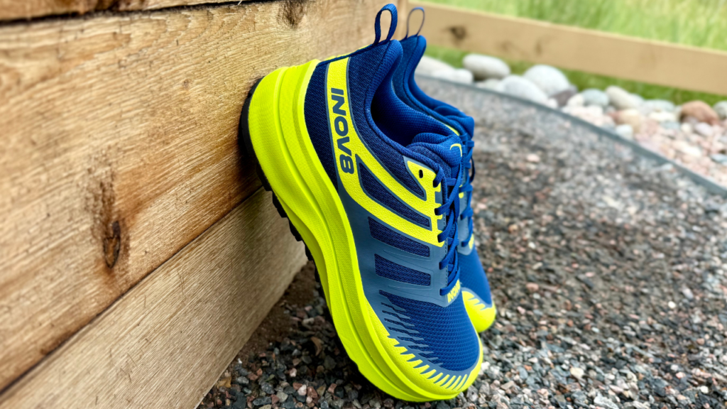 Inov-8 Trailfly Max leaning on wall